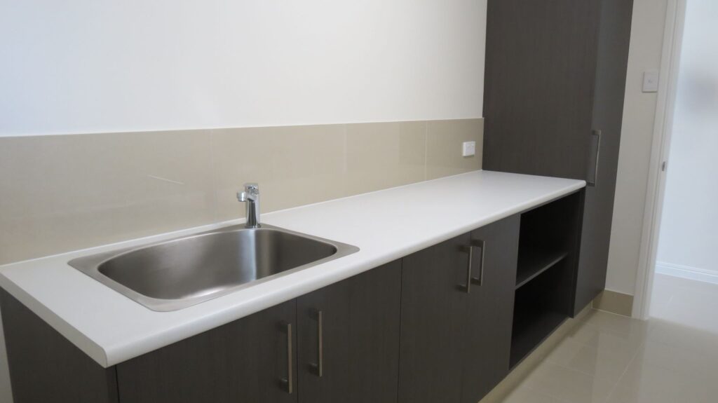 Laundry renovation with woodgrain cabinets - Salisbury QLD