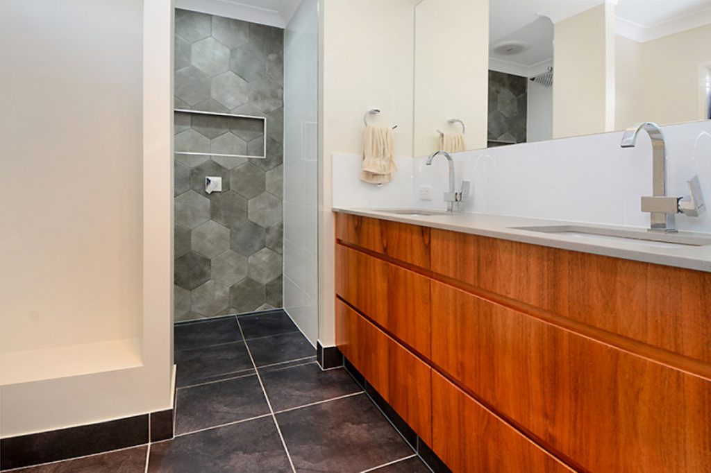 Main bathroom with hexagon tiles and wood grain vanity - Mount Gravatt QLD