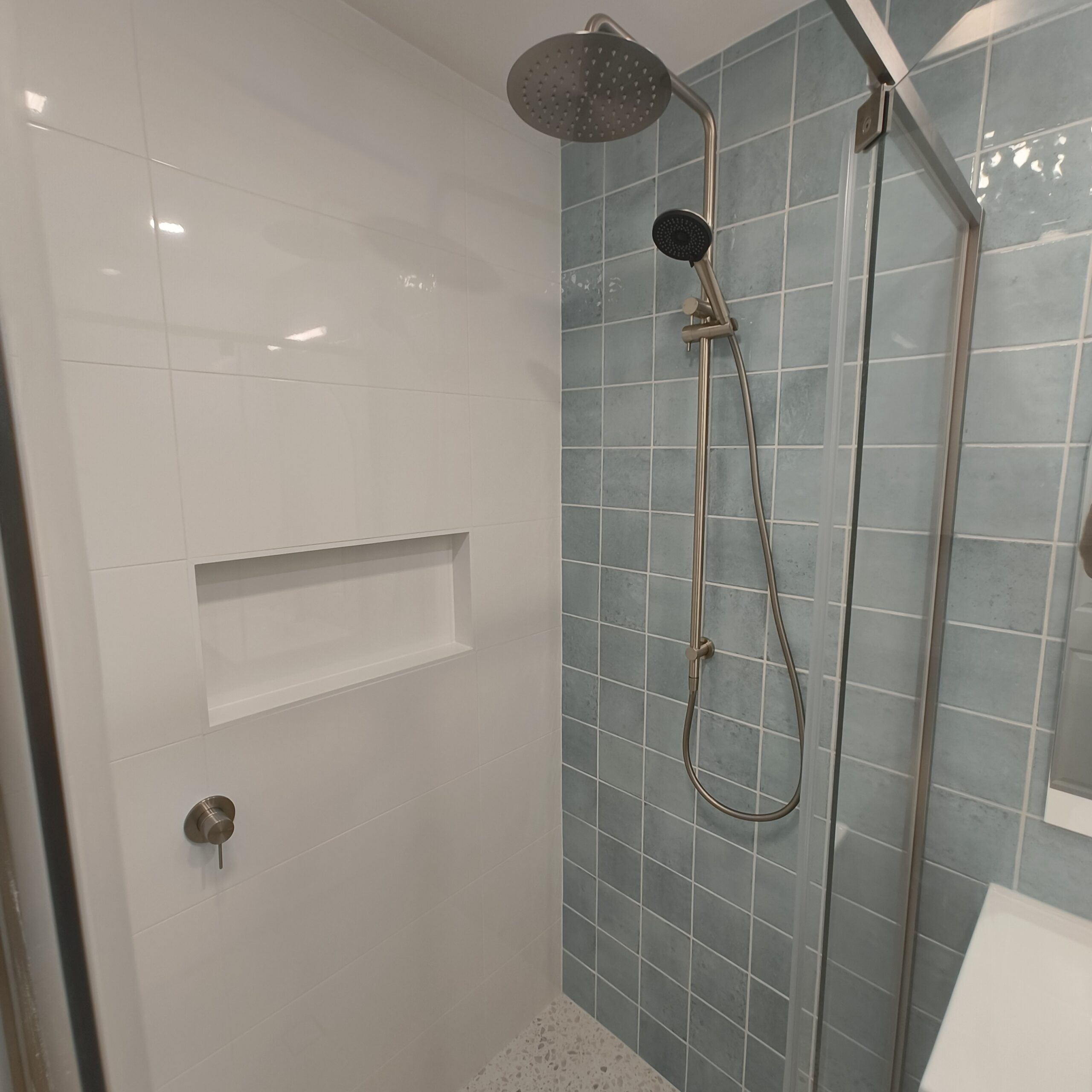 Ensuite bathroom renovation in Yeerongpilly with arched mirror and timber veneer vanity
