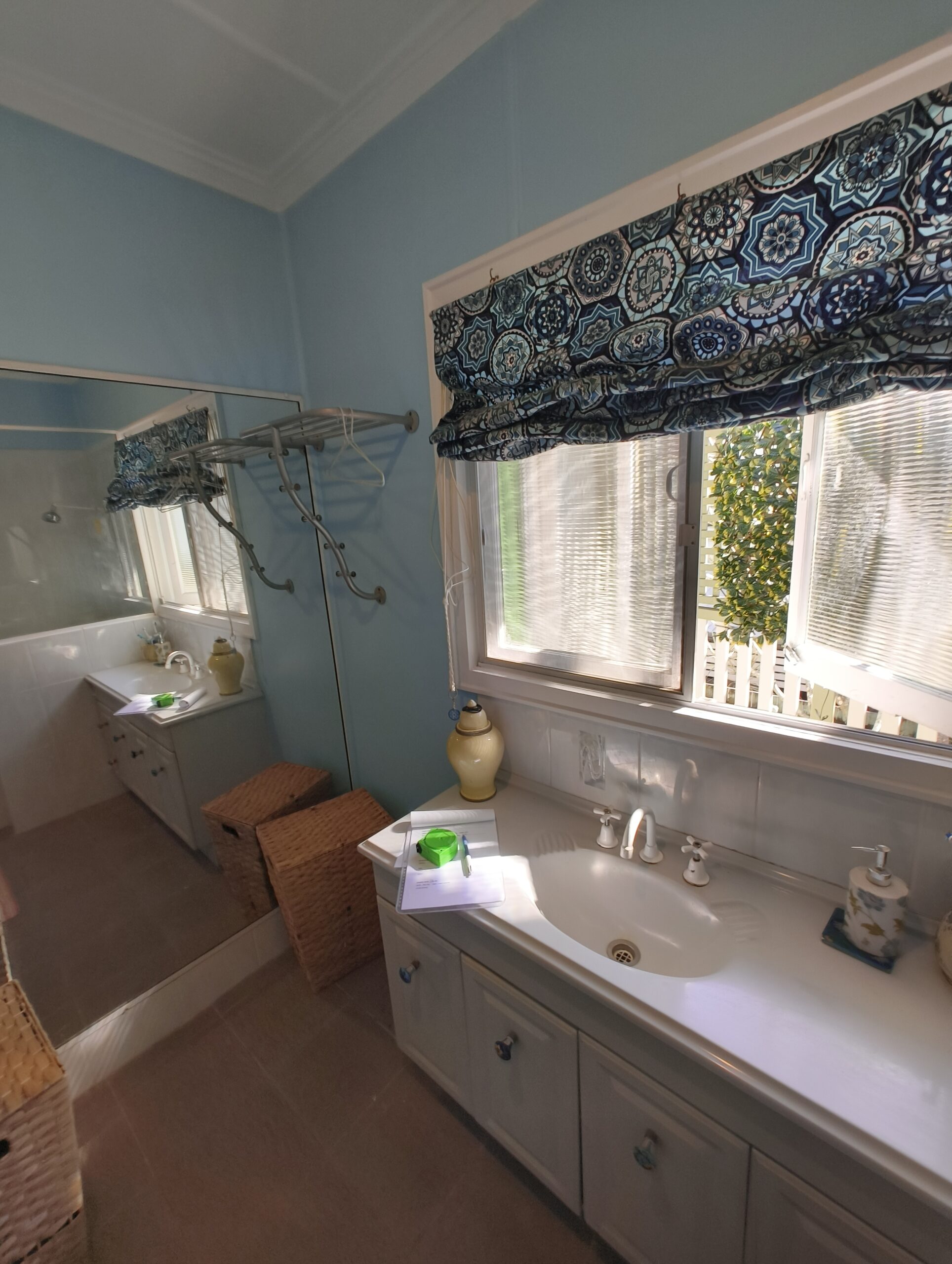 Graceville Queenslander bathroom before renovation with pale blue walls and old vanity