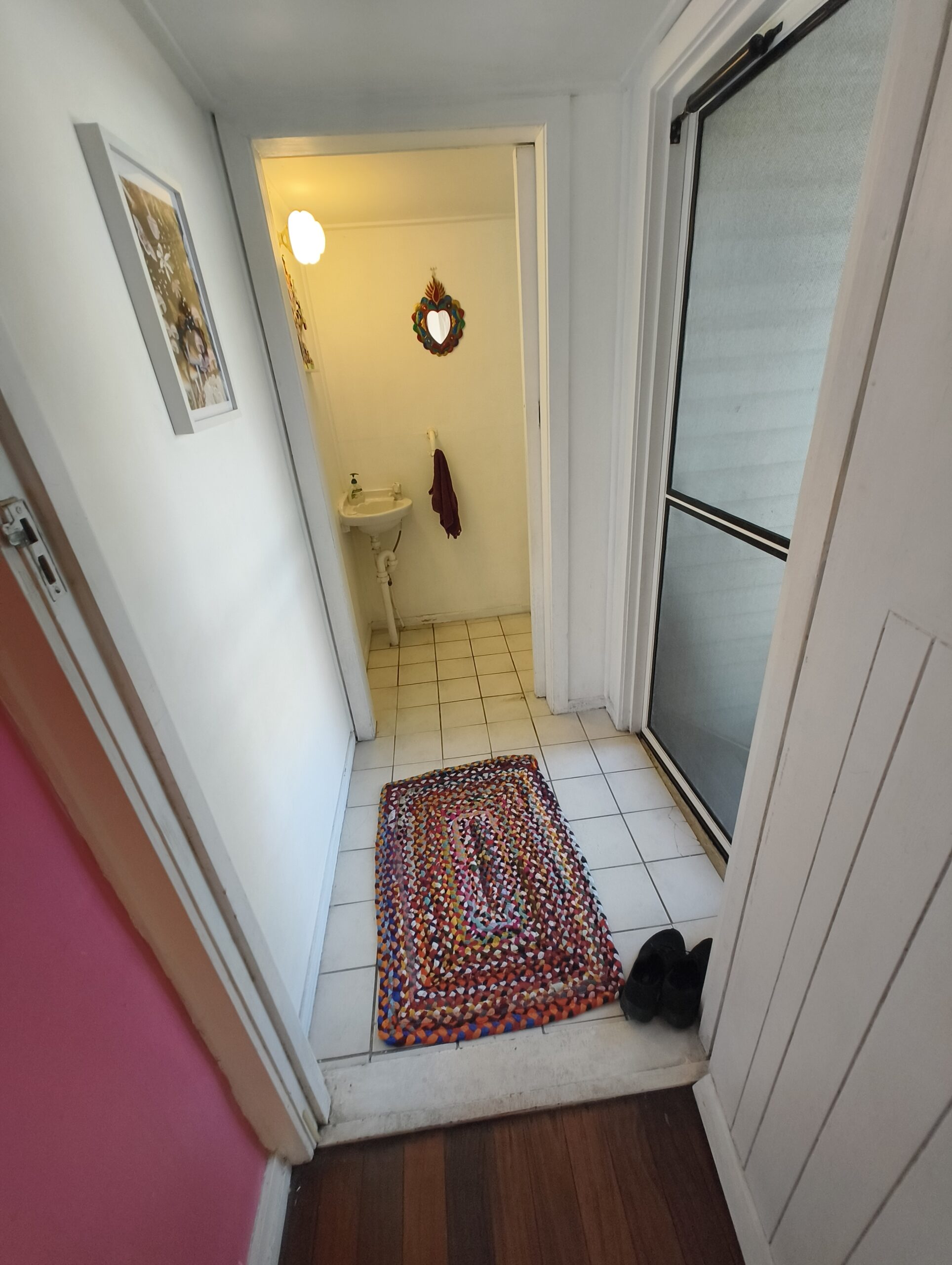 Graceville Queenslander landing and hallway before renovation with old white floor tiles