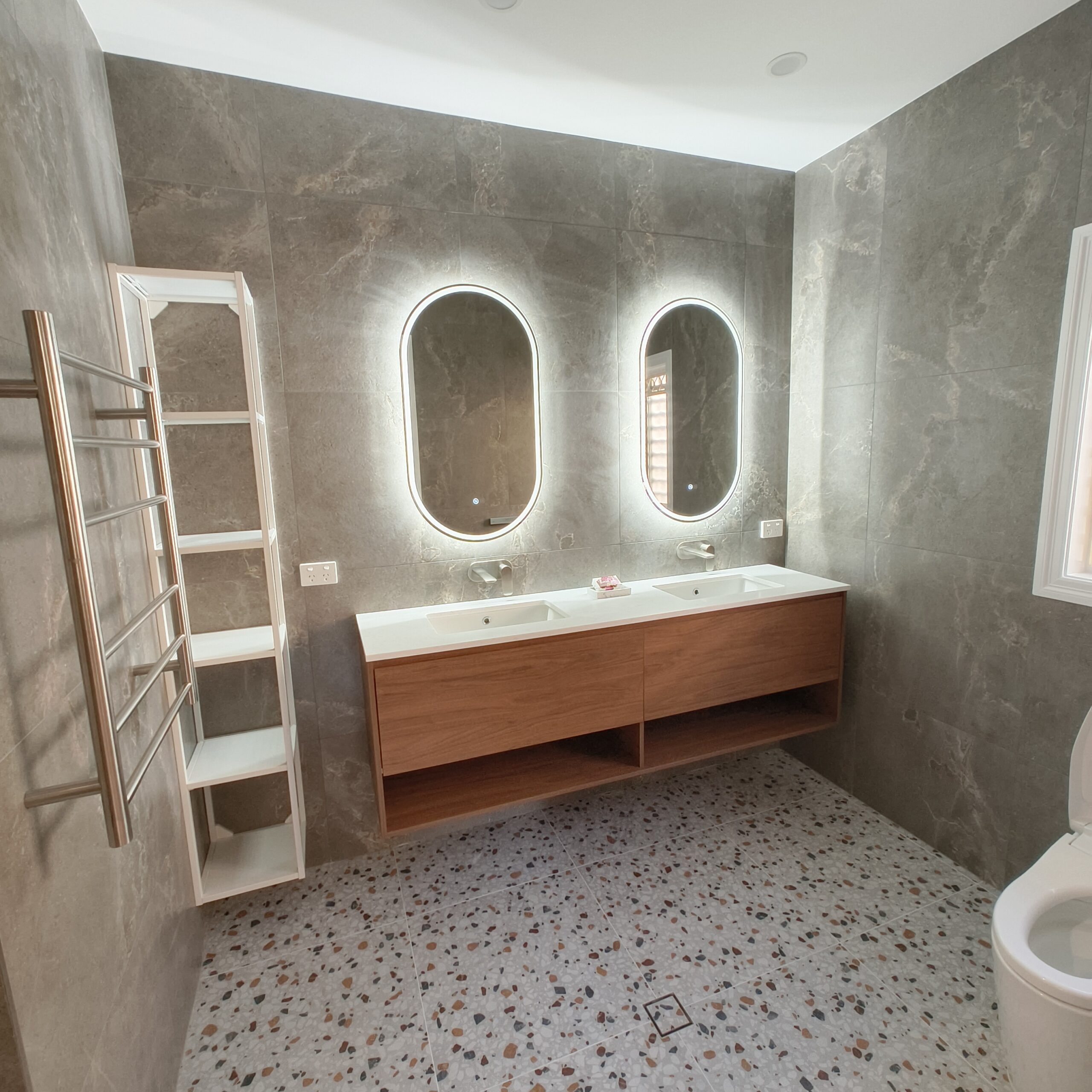 Large East Brisbane ensuite after renovation with double vanity, backlit mirrors and Linsol heated towel rail