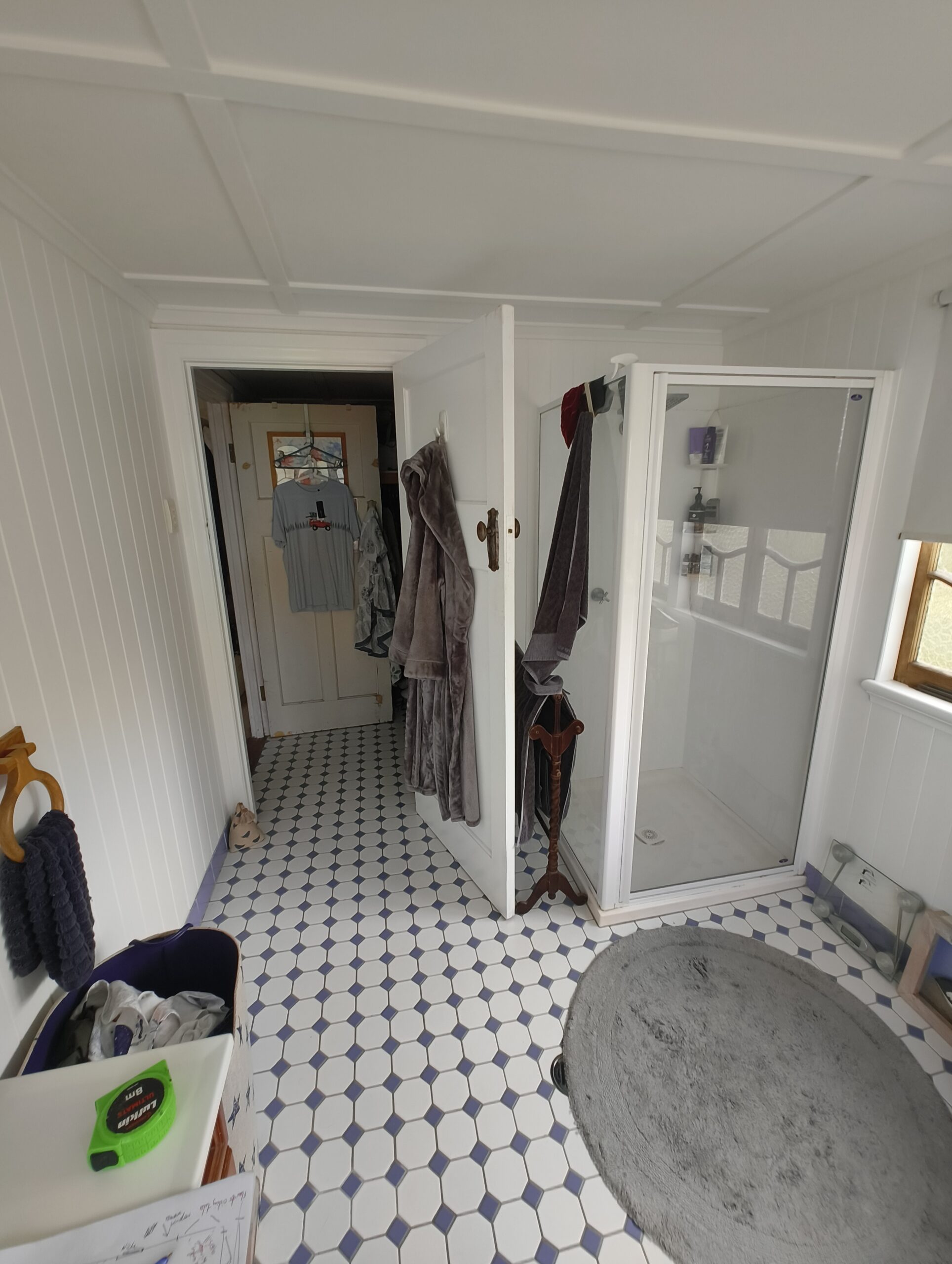 Ensuite before renovation with entry through the walk-in robe and old corner shower