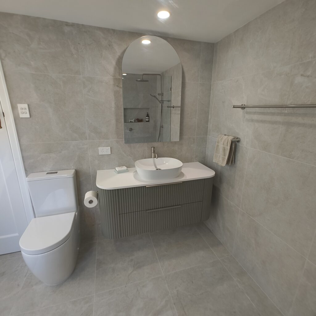 Woolloongabba ensuite renovation with Marquis Shore 1200 wall-hung vanity in Church Topiary green and arched mirror