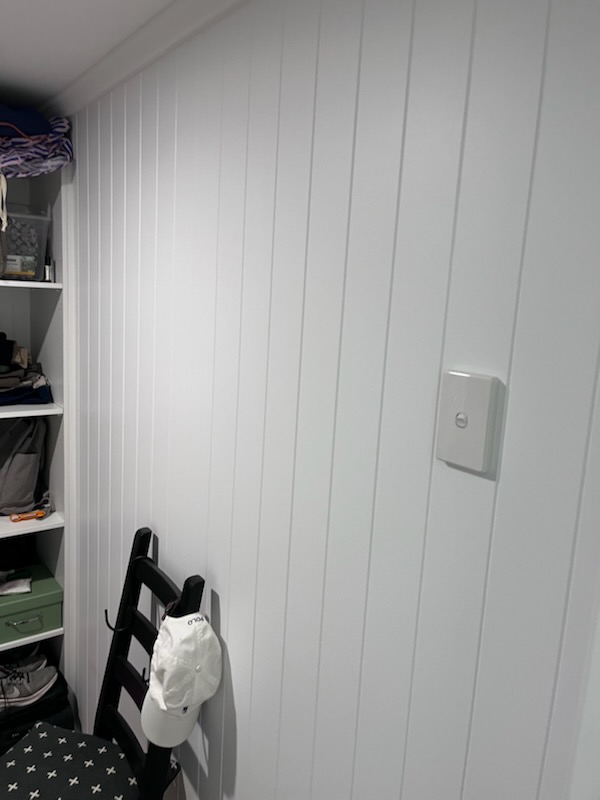 Renovated walk-in robe with white melamine storage in the Woolloongabba Queenslander