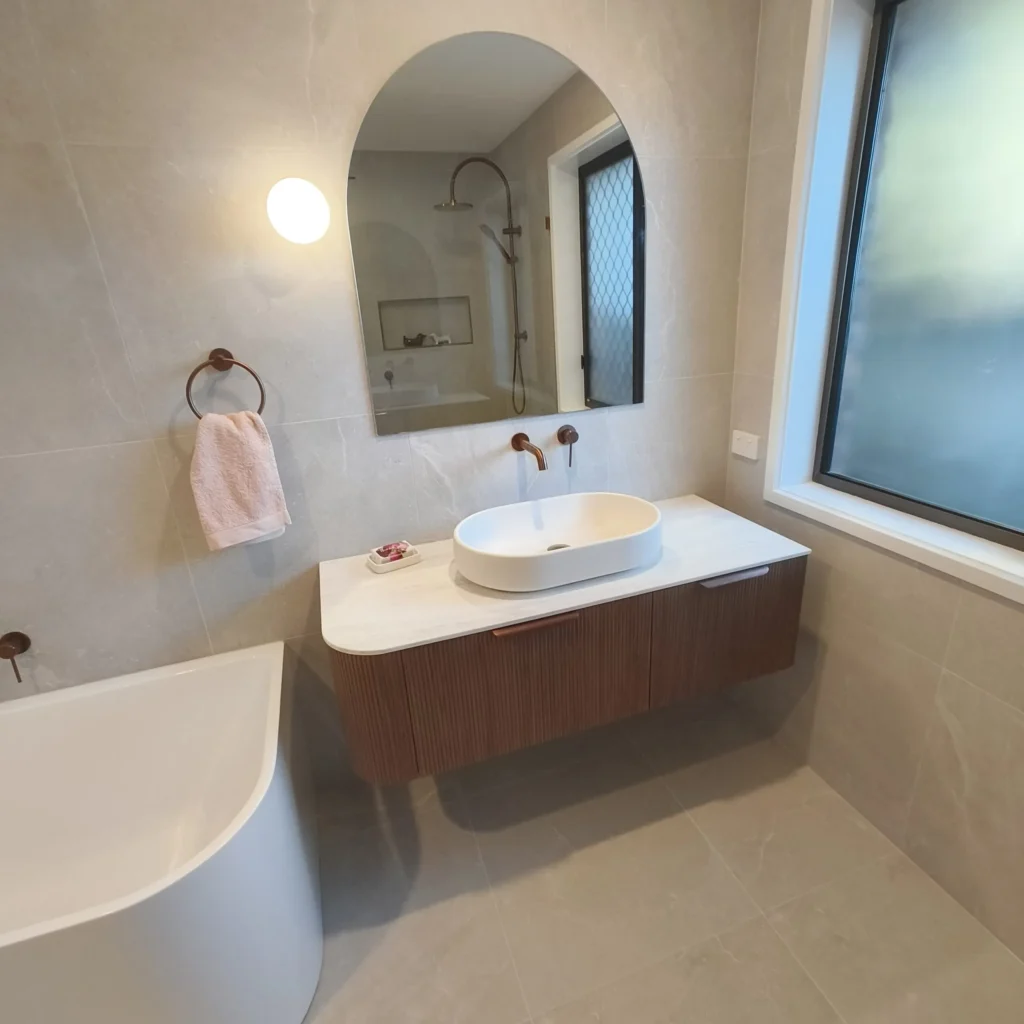 Finished Eight Mile Plains bathroom with fluted timber vanity and wall mounted basin mixer