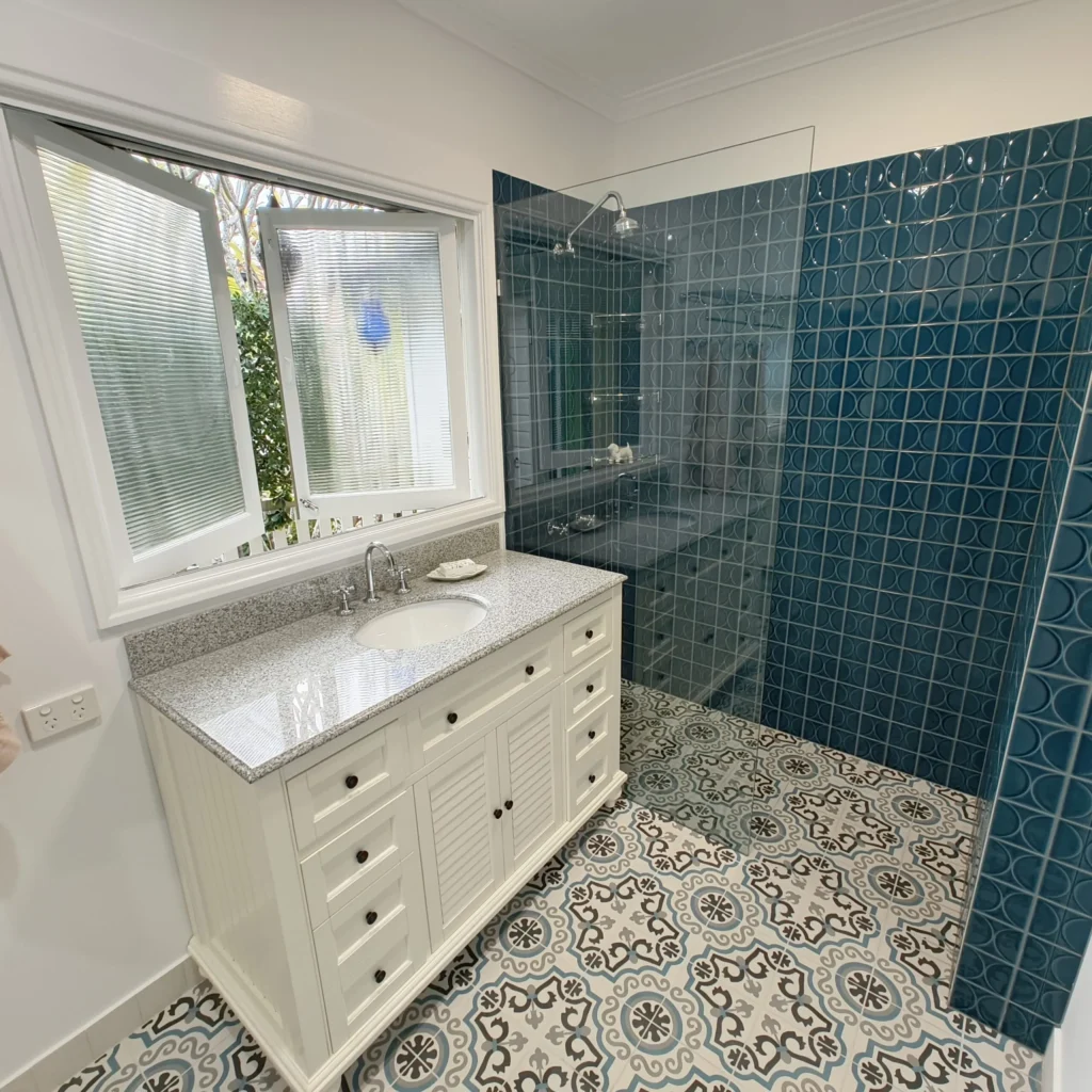 Graceville bathroom renovation with walk-in shower, glass shelving and green-blue feature tiles