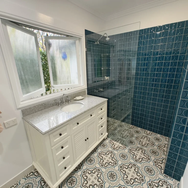 Graceville bathroom renovation with walk-in shower, glass shelving and green-blue feature tiles