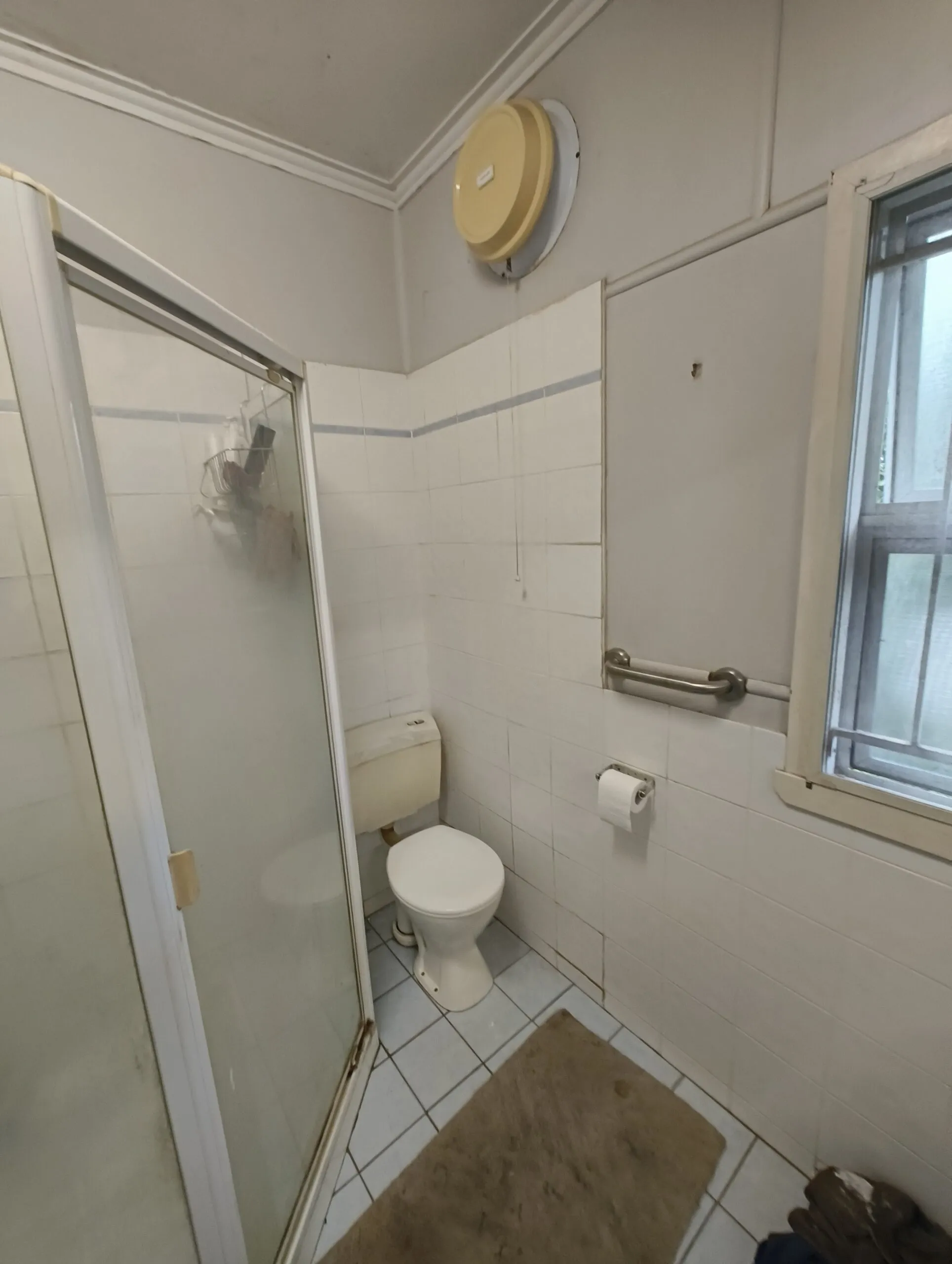 Original bathroom storage cupboards before Norman Park renovation