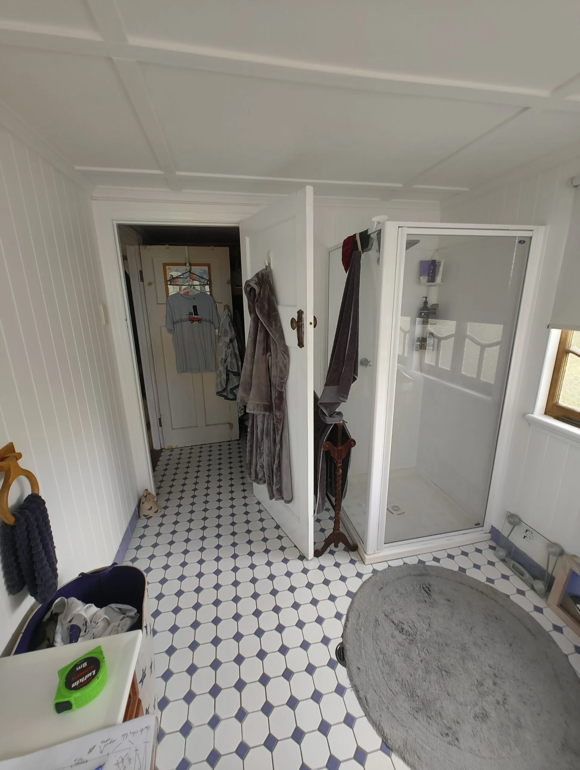 Ensuite before renovation with entry through the walk-in robe and old corner shower