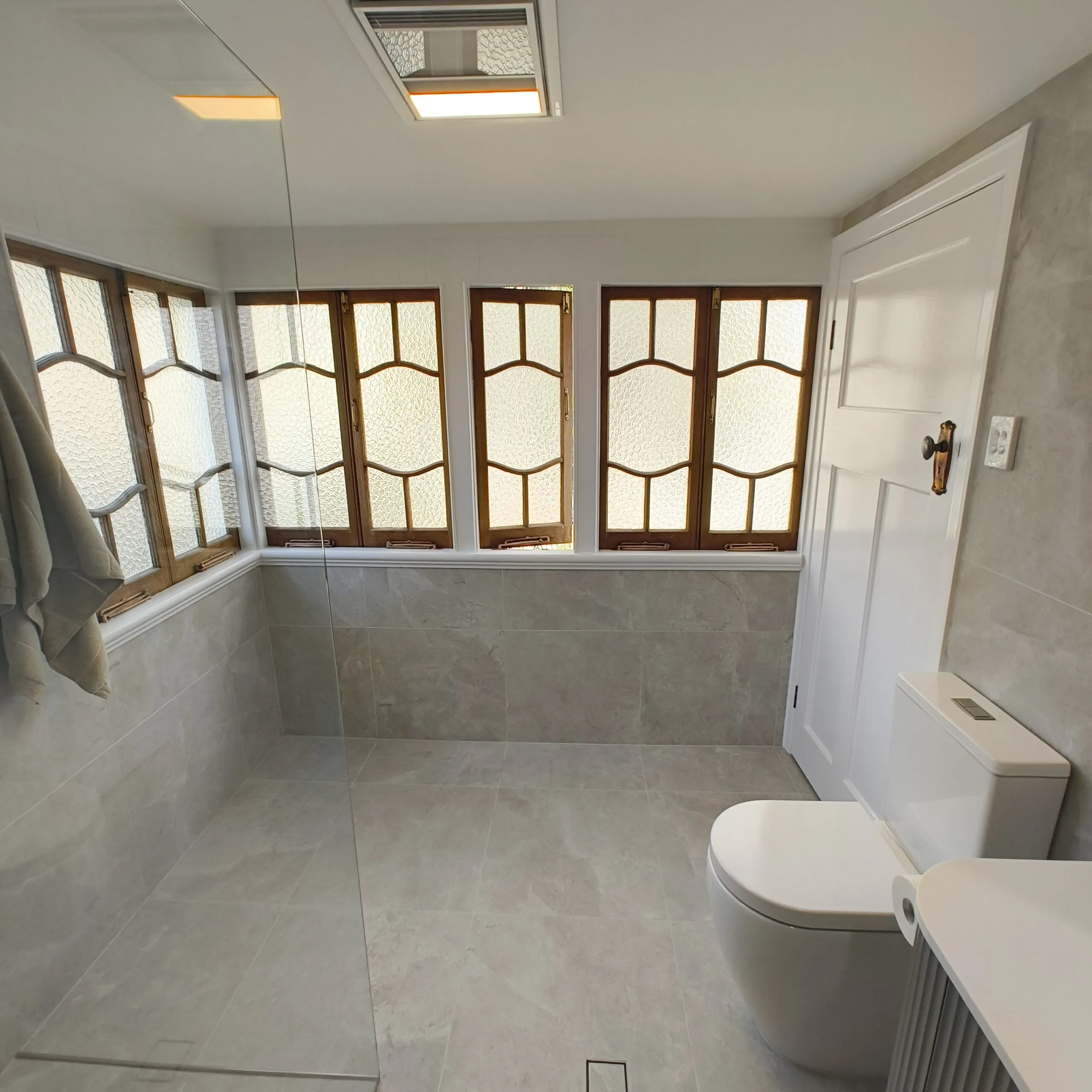 Renovated ensuite in the Woolloongabba Queenslander with Tun Ivory Matt tiles and brushed nickel fittings