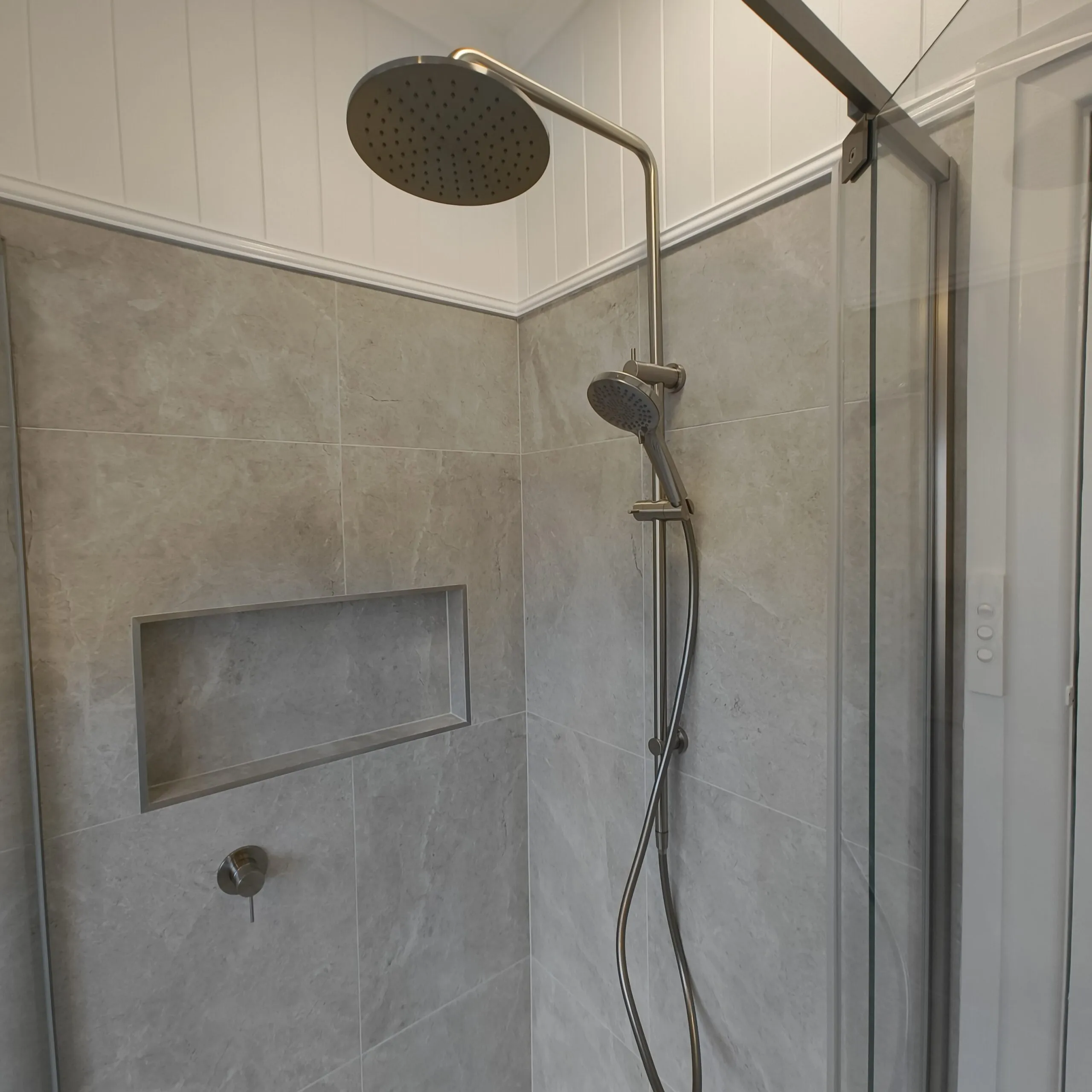 Rain shower and VJ panelling above Tun Ivory Matt tiles in the renovated Woolloongabba main bathroom