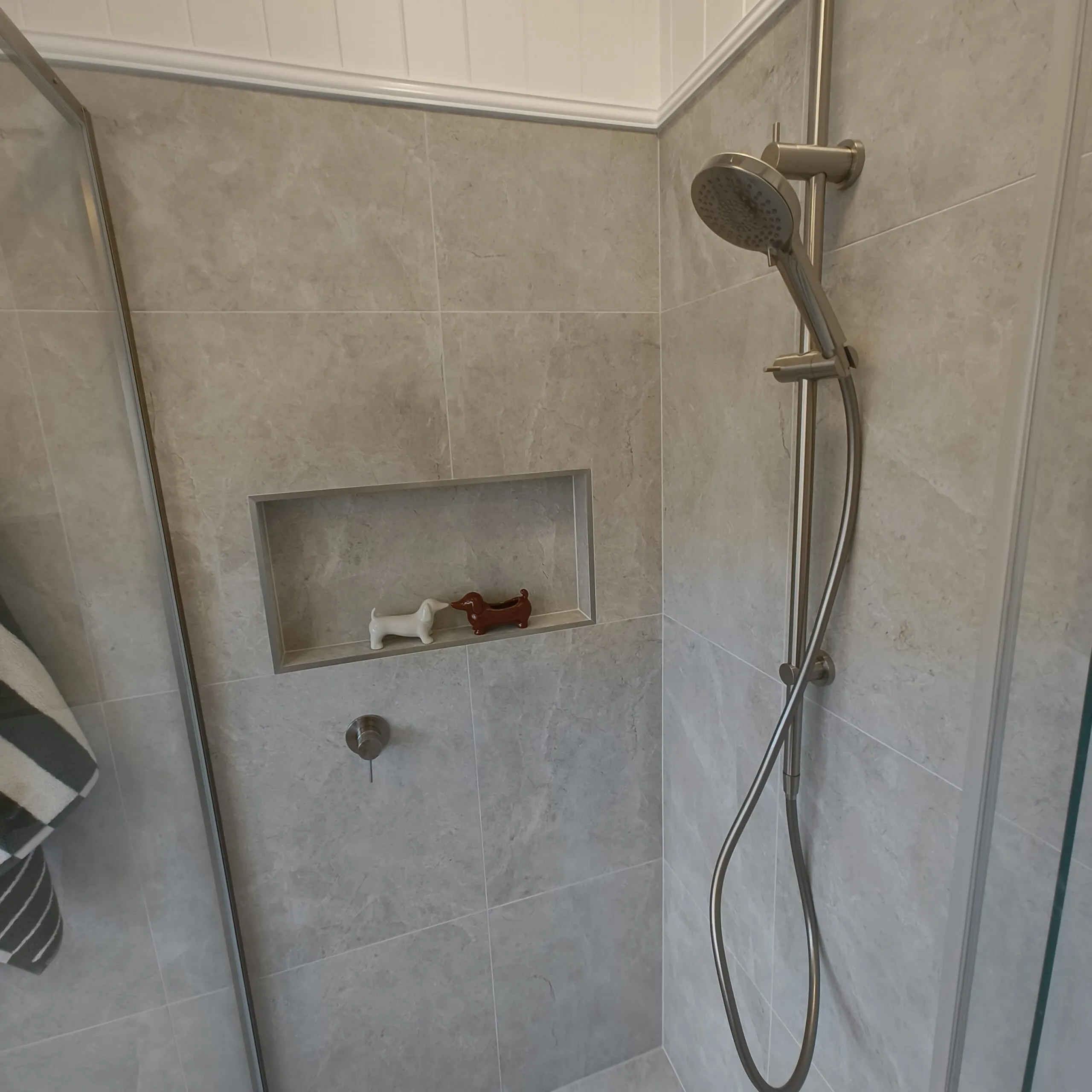 Renovated Woolloongabba main bathroom shower with Tun Ivory Matt tiles, niche and brushed nickel rail shower