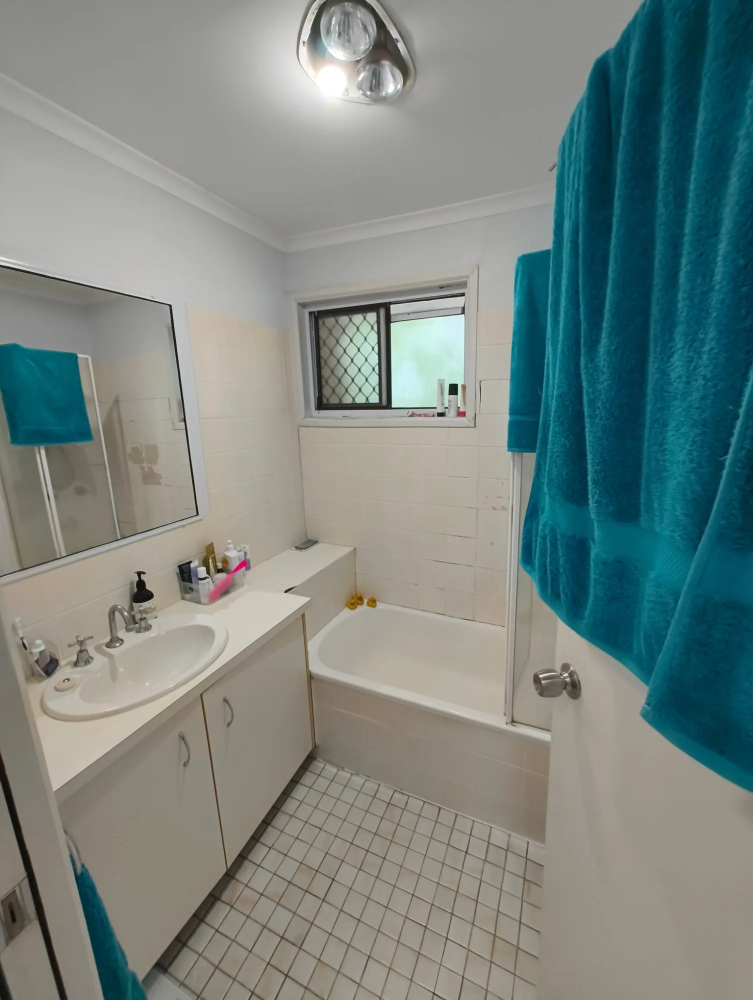 Red Hill bathroom before renovation with dated cream tiles, bath and vanity