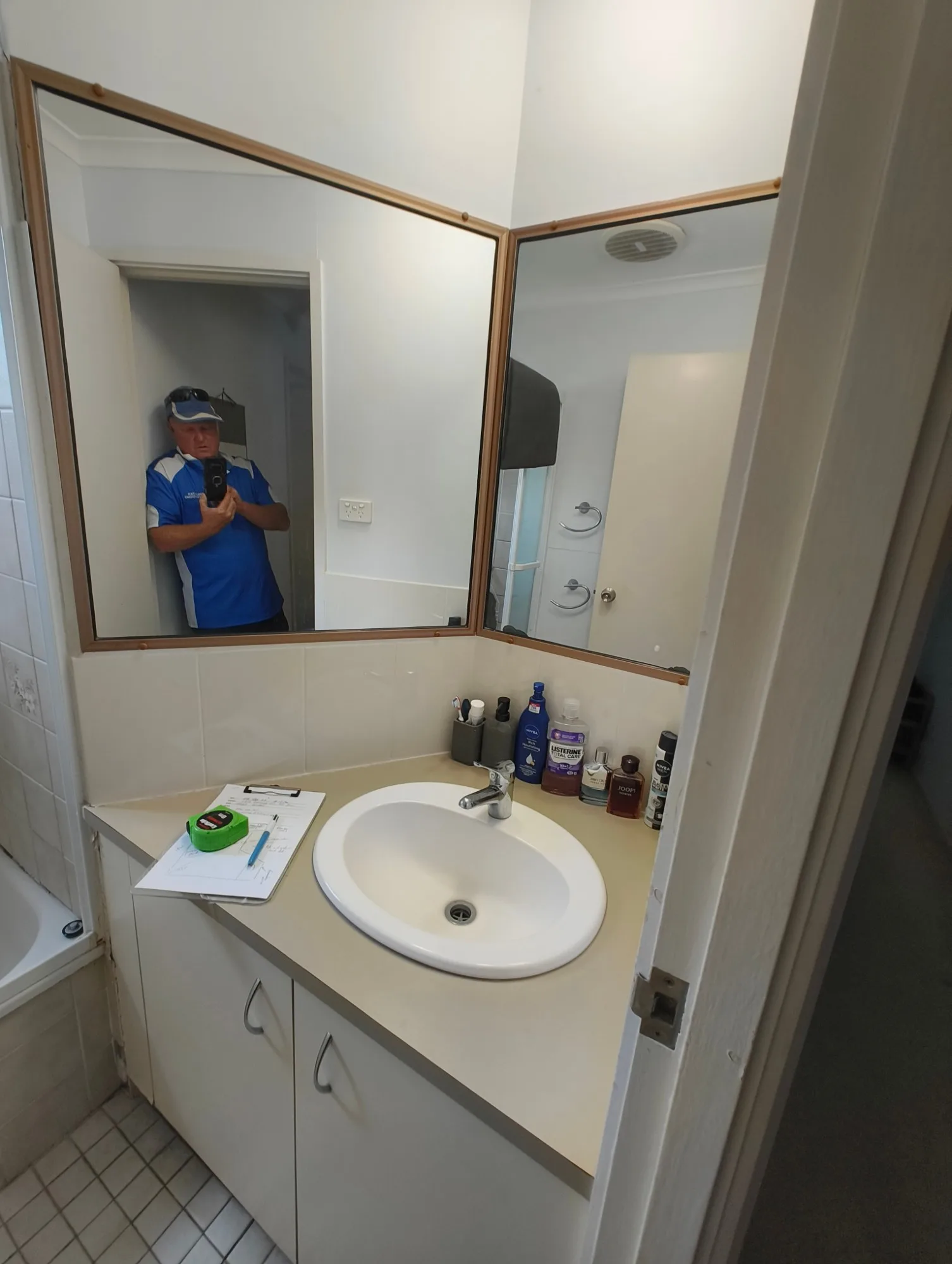 Original vanity and corner mirror in the Red Hill bathroom before renovation