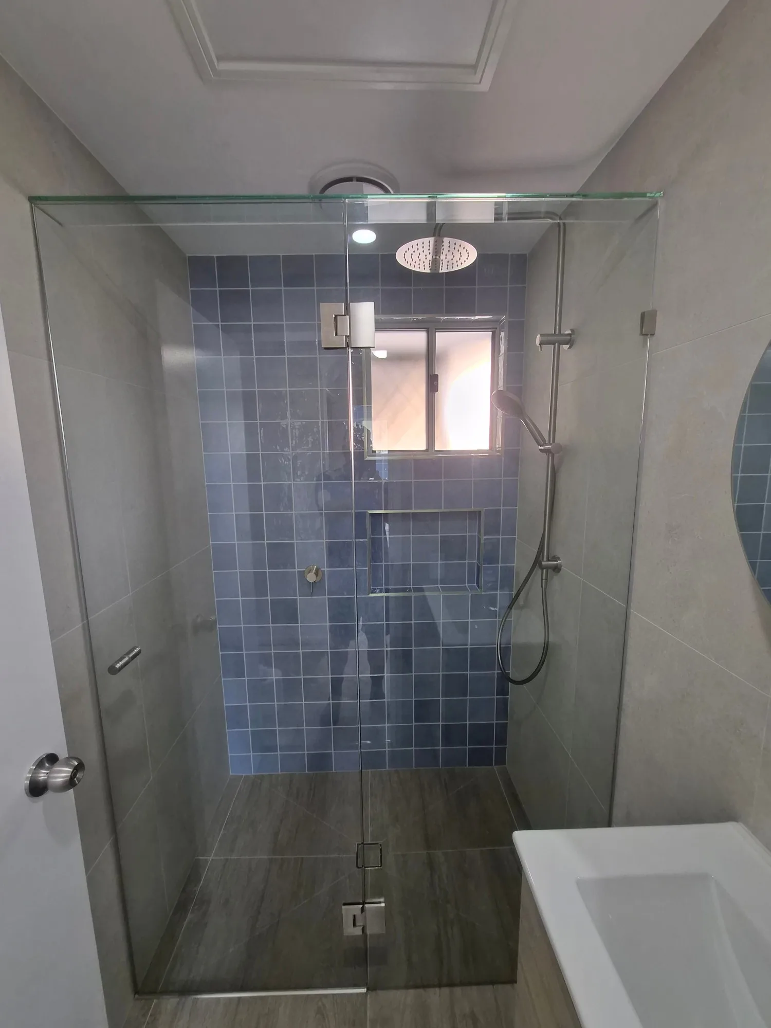 Frameless shower with blue feature wall and new Bradnams window in the Red Hill ensuite renovation