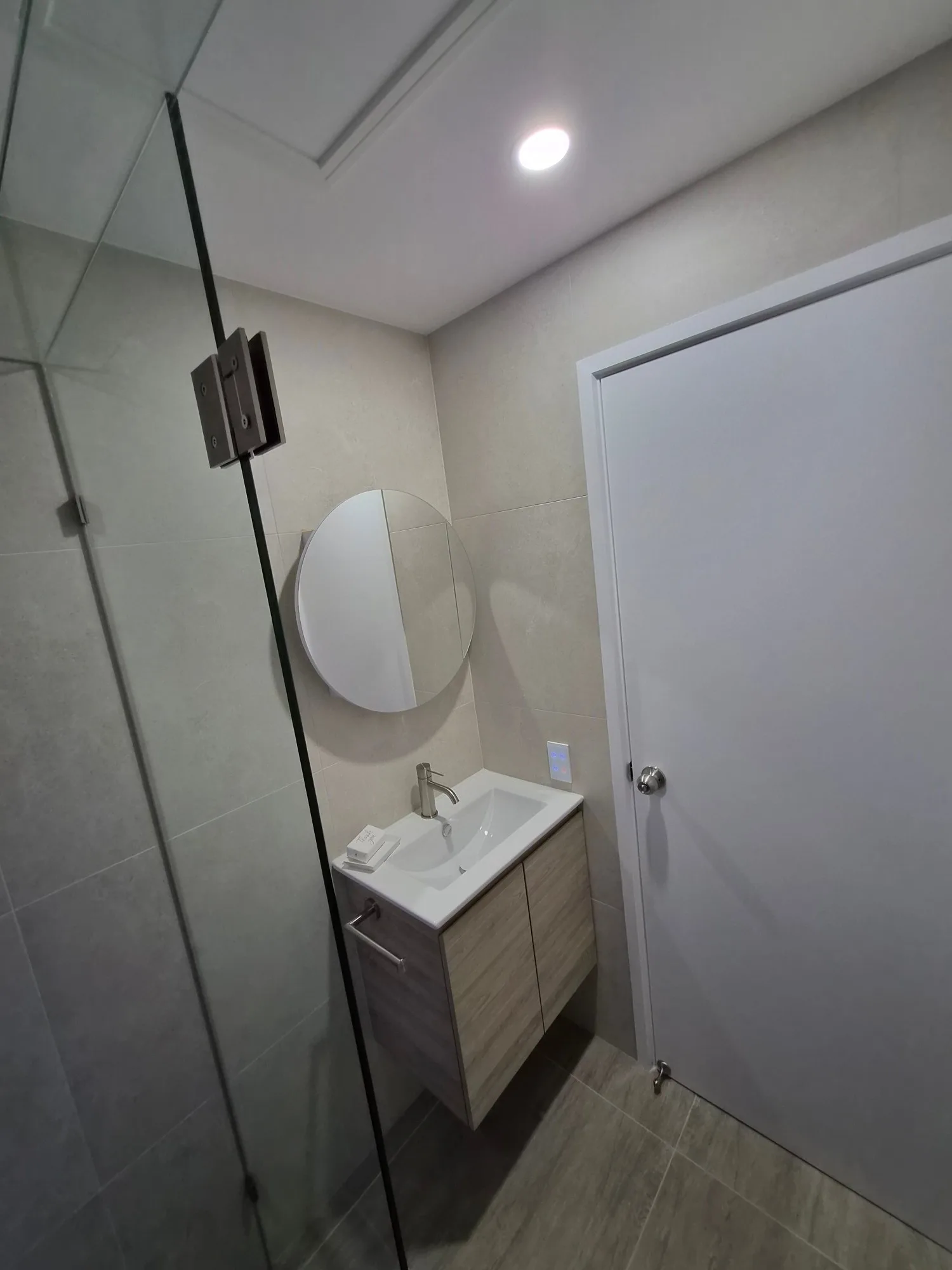 Red Hill ensuite renovation with ADP Glacier wall-hung vanity, round mirror cabinet and frameless shower