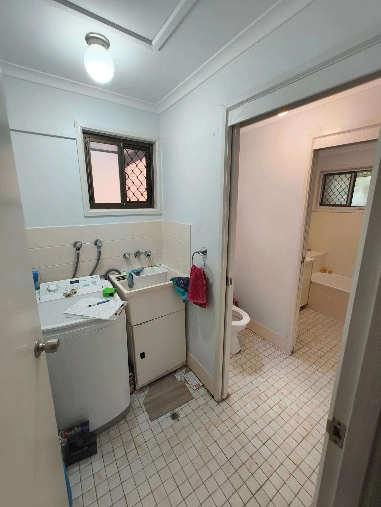 Combined laundry, toilet and bathroom in the Red Hill townhouse before renovation