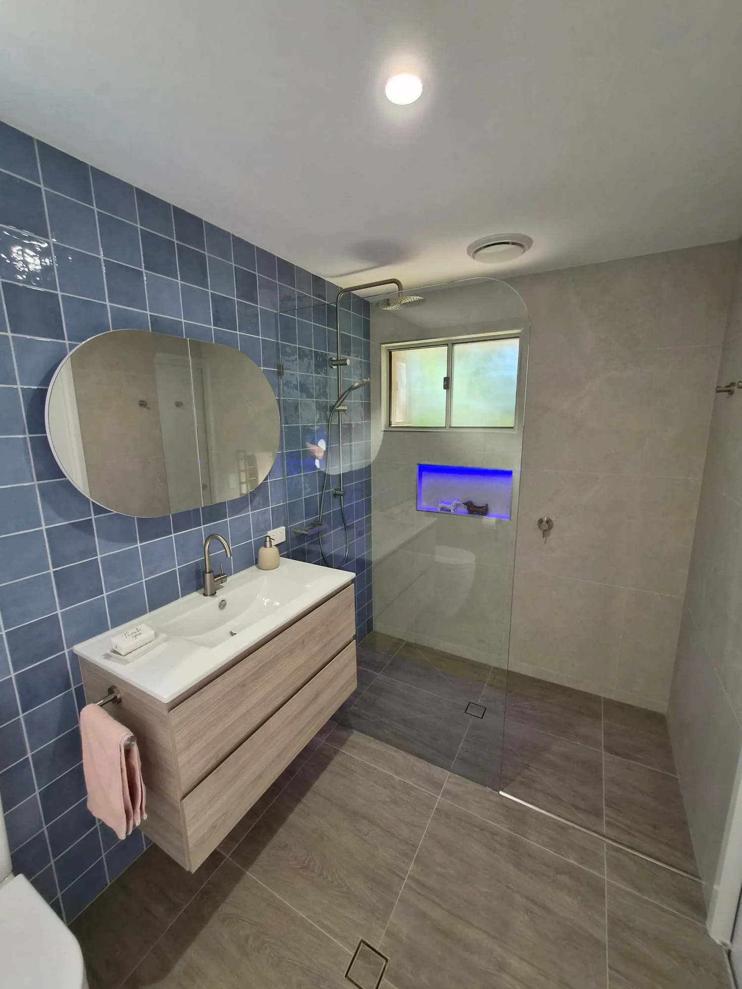 Red Hill main bathroom renovation with blue Mertilo feature wall, ADP Glacier vanity and walk-in shower