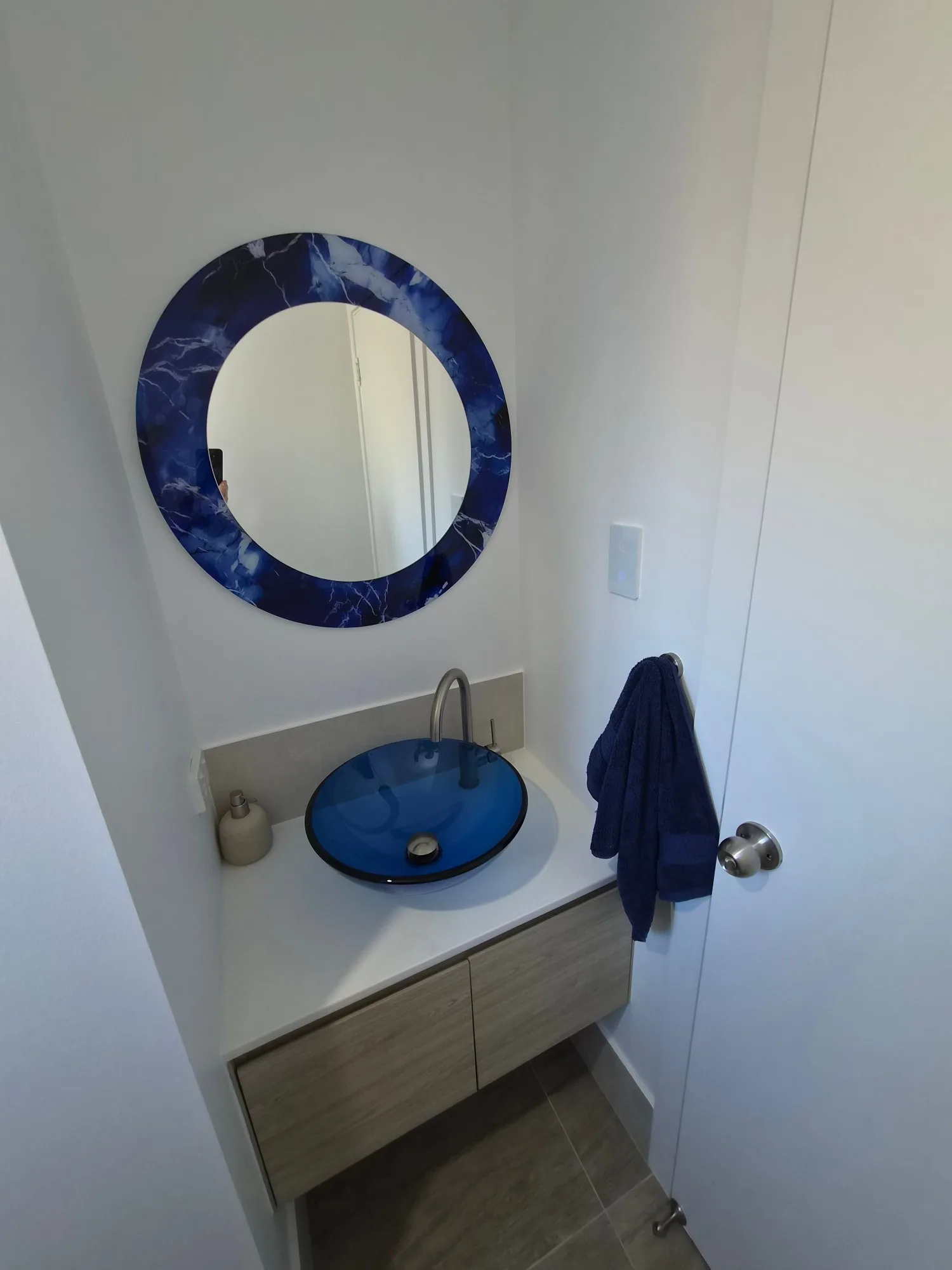 Red Hill powder room renovation with blue glass basin, blue marble mirror and brushed nickel tap
